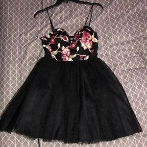 A black dress with floral imprint on top of chest